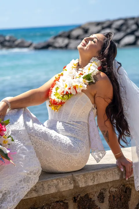 Lila in her plumeria lei by the water