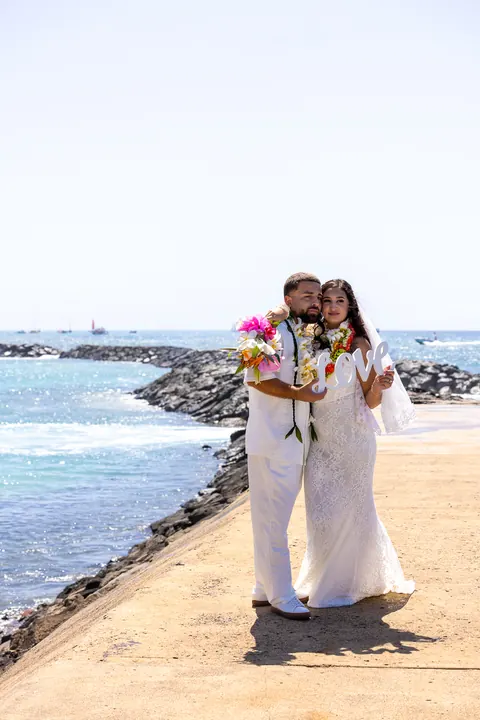 The couple on the rocks by the Magic Island breakwater
