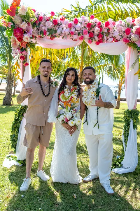 The couple with friends under the palms