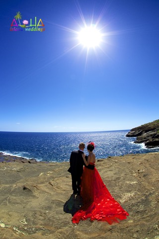 A bride in a red dress on the Makapuu cliffs