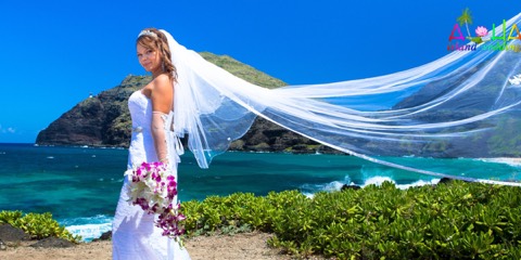 Stephanie with her veil blowing in the wind before her ceremony at Makapuu