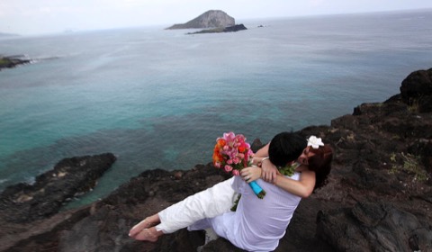 The couple on the rocks with Rabbit Island offshore