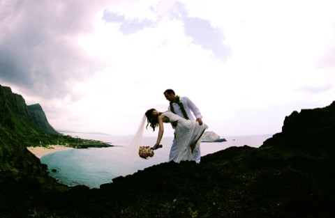 Beth and her groom above the coastline