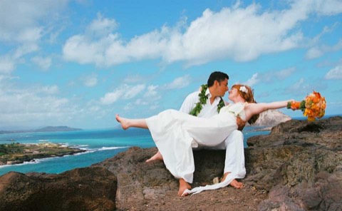 Ashley and her husband on the lava rock point above the bay