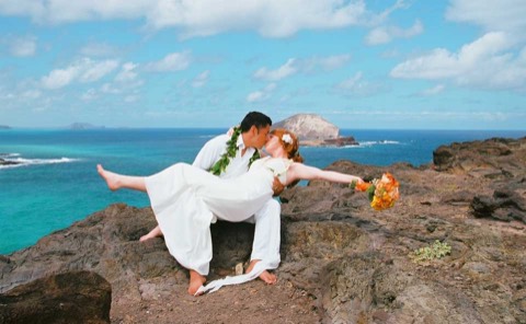 A kiss on the cliffs with Rabbit Island behind them
