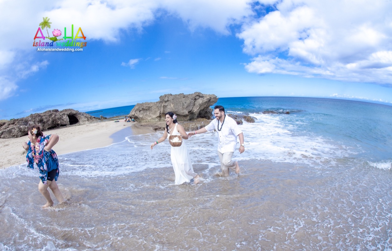 A simple beach ceremony at Makua on Oahu with the couple, their family and a heart of leaves in the sand
