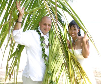 couple looking through the palm trees