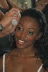Naheshae getting ready with a white flower in her hair, from another angle