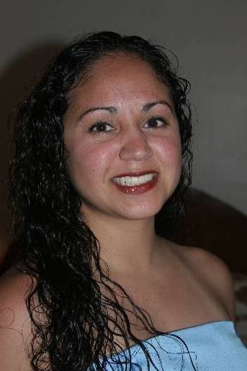 Naheshae getting ready with a white flower in her hair, smiling