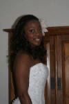 Naheshae getting ready with a white flower in her hair, close up