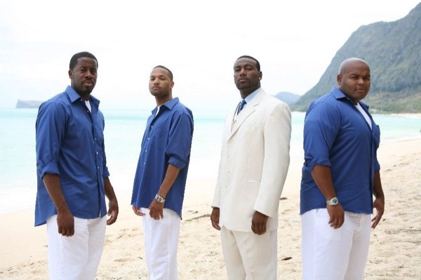 The bridal party in blue on the beach, in the afternoon light