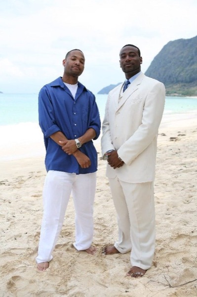 Damarus with his groomsmen in royal blue, looking at each other