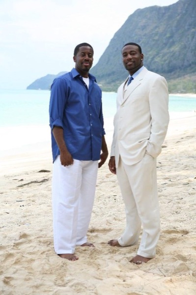 The bridal party in blue on the beach, wide view