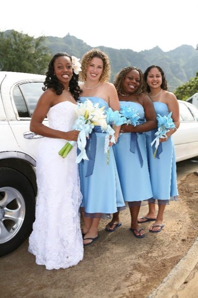 The bridal party in blue on the beach, in a happy moment