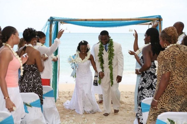 Guests seated on the sand under the ironwood trees, looking at each other