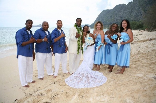 Damarus with his groomsmen in royal blue, under a blue sky