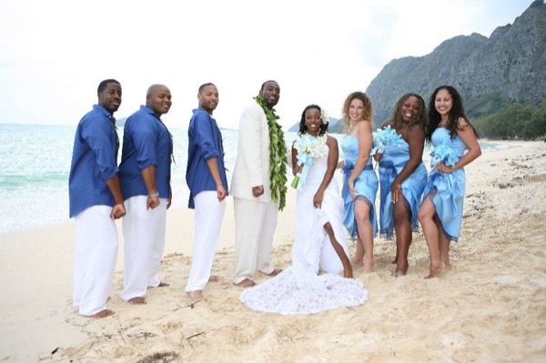 Naheshae with her bridesmaids in light blue, under a blue sky