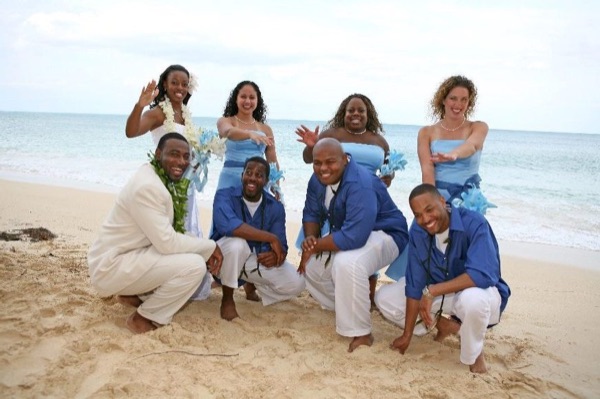 The bridal party in blue on the beach, in the sunshine