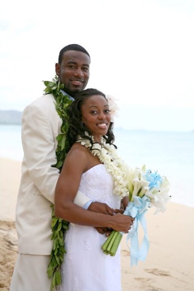 Naheshae and Damarus on the beach with the mountains behind them, laughing together