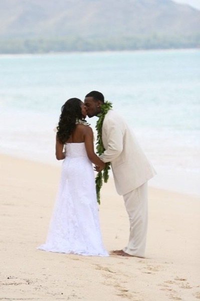 A kiss on the beach, laughing together