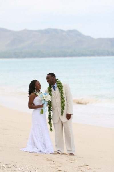 Naheshae and Damarus on the beach with the mountains behind them, under a blue sky