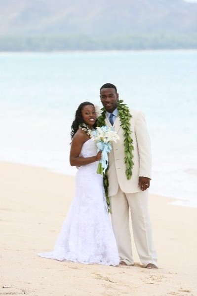 Naheshae and Damarus by the water, under a blue sky