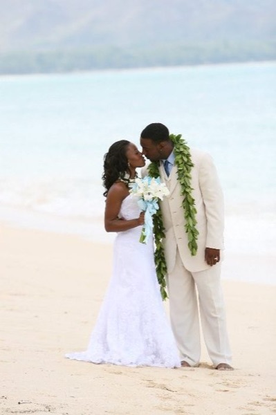 A kiss on the beach, under a blue sky
