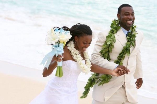 Naheshae and Damarus on the beach with the mountains behind them, wide view