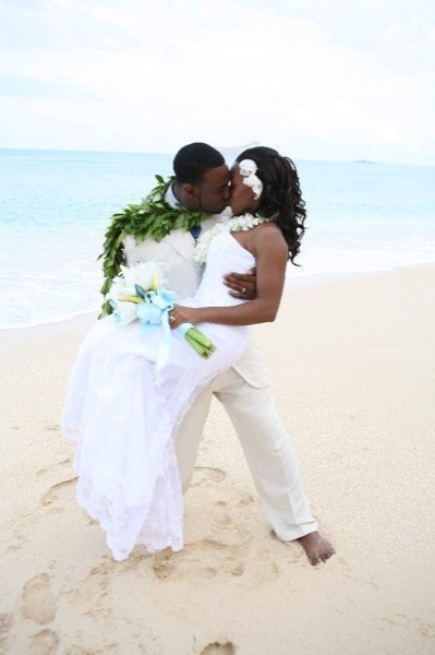 A kiss on the beach, looking at each other