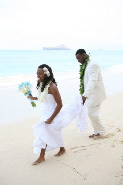 Naheshae and Damarus on the beach with the mountains behind them, having fun
