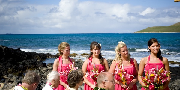 Family watching the ceremony by the lava rocks, another view