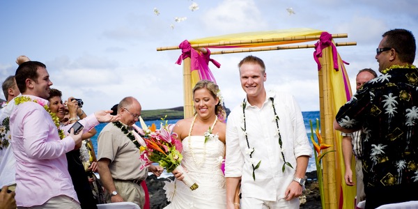 Natasha and Tyson under the magenta and mango arch, a moment later