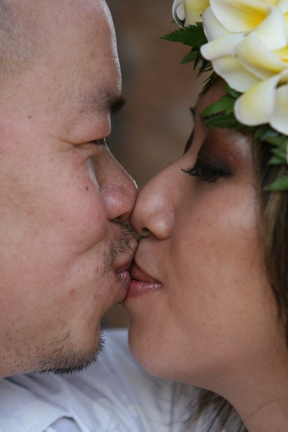 togther after wedding wearing yellow plumeria flowers