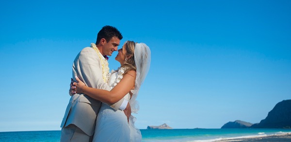 Bride and groom gazing into each other's eyes after their beach wedding vows