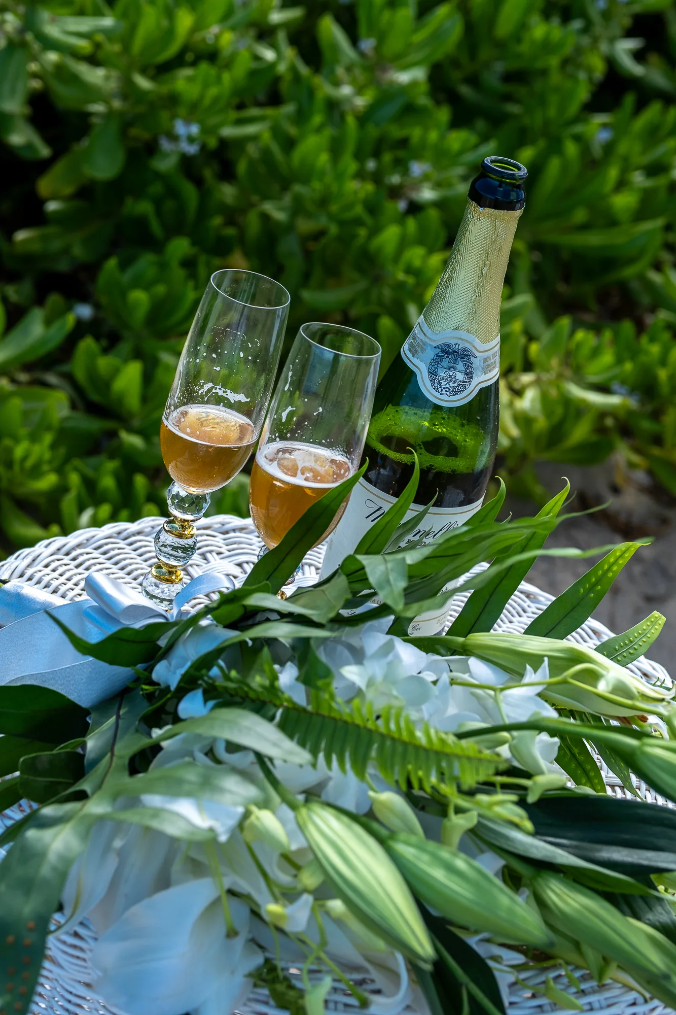 Champagne glasses resting in the greenery