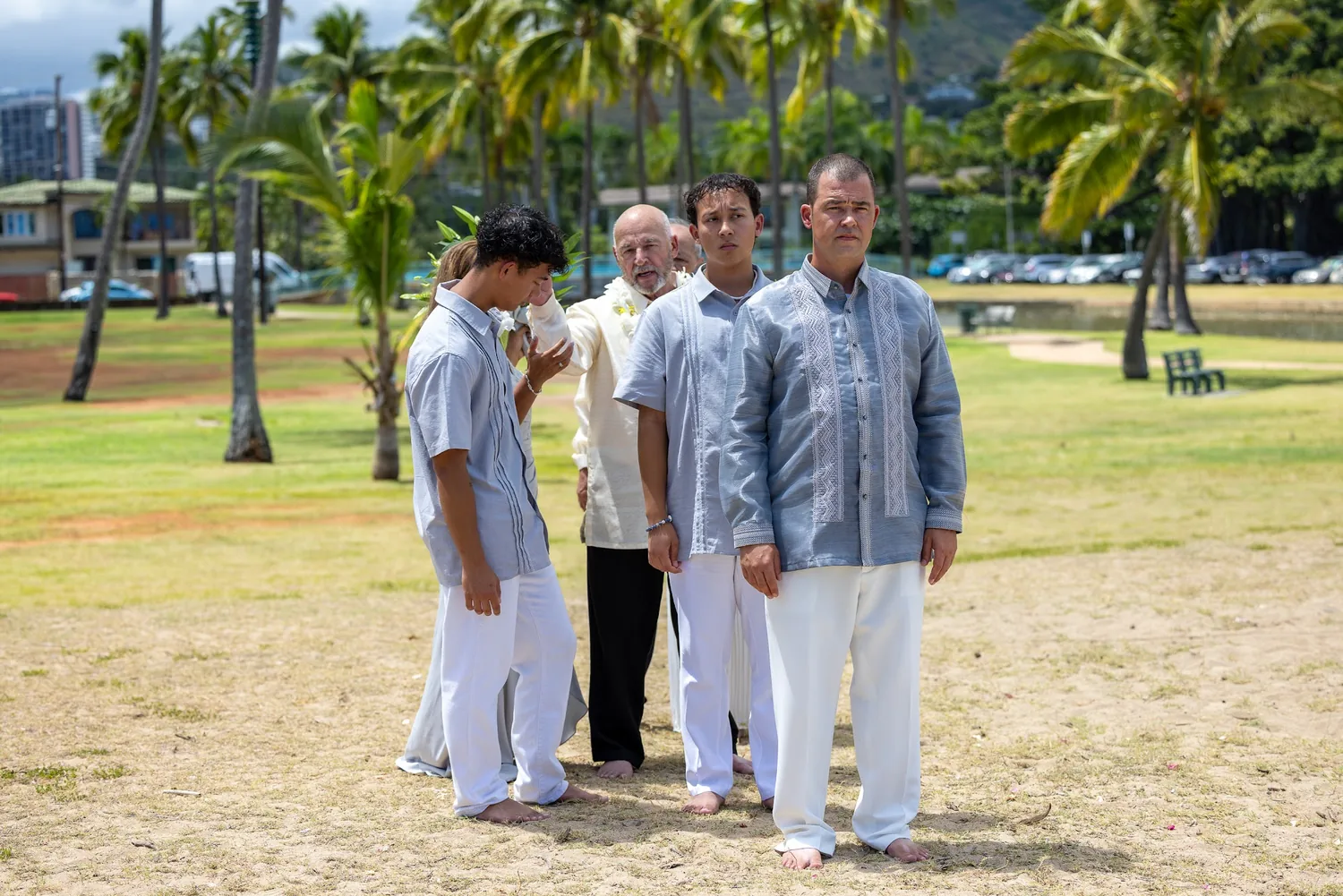 The family walking to the ceremony under the palms