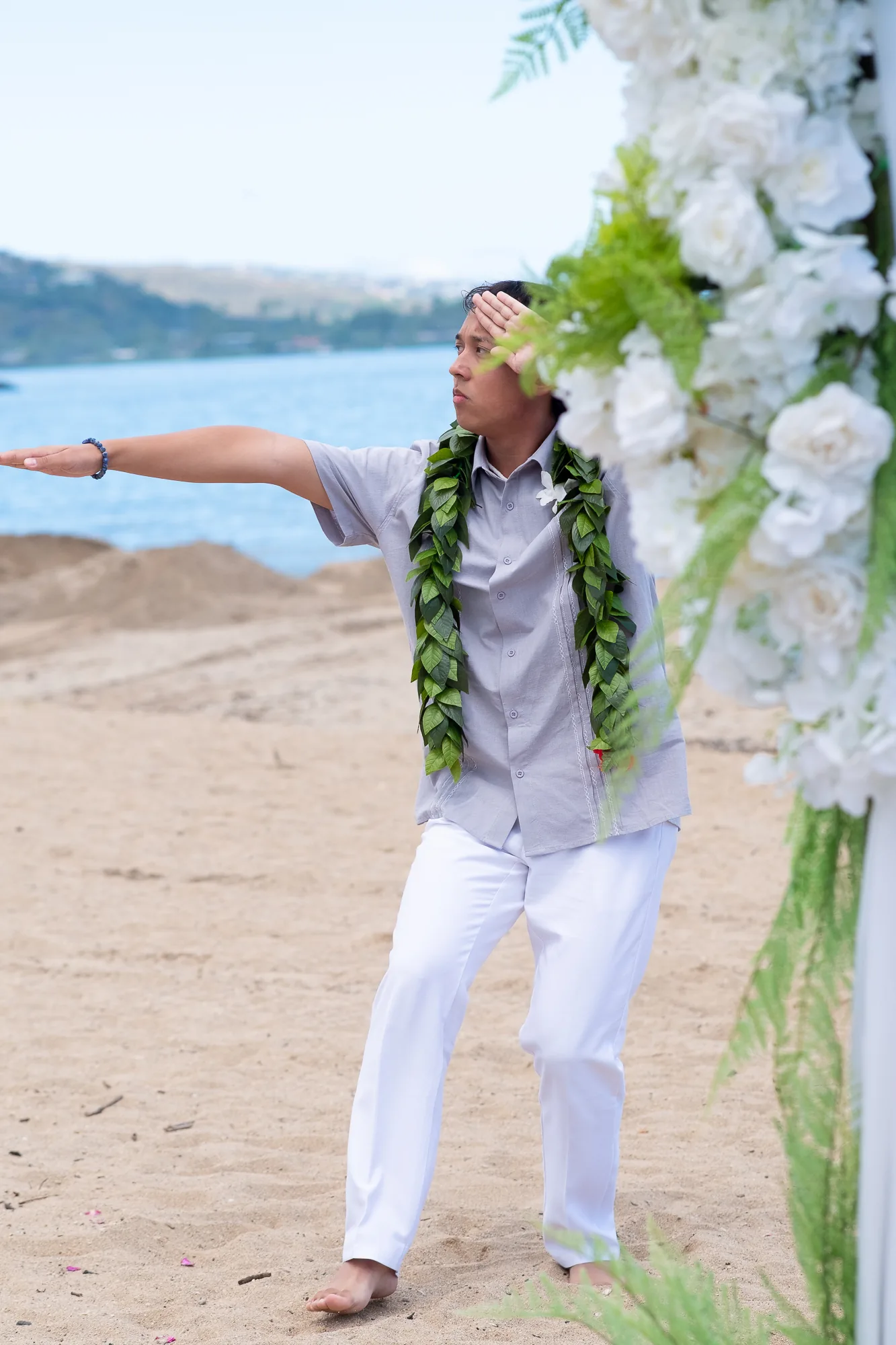 Dancing hula beside the bamboo arch