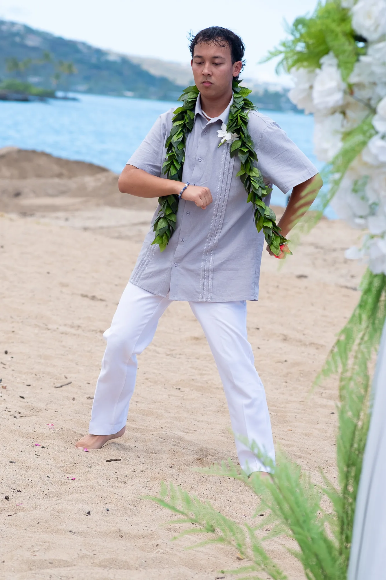 Their son dancing hula on the beach
