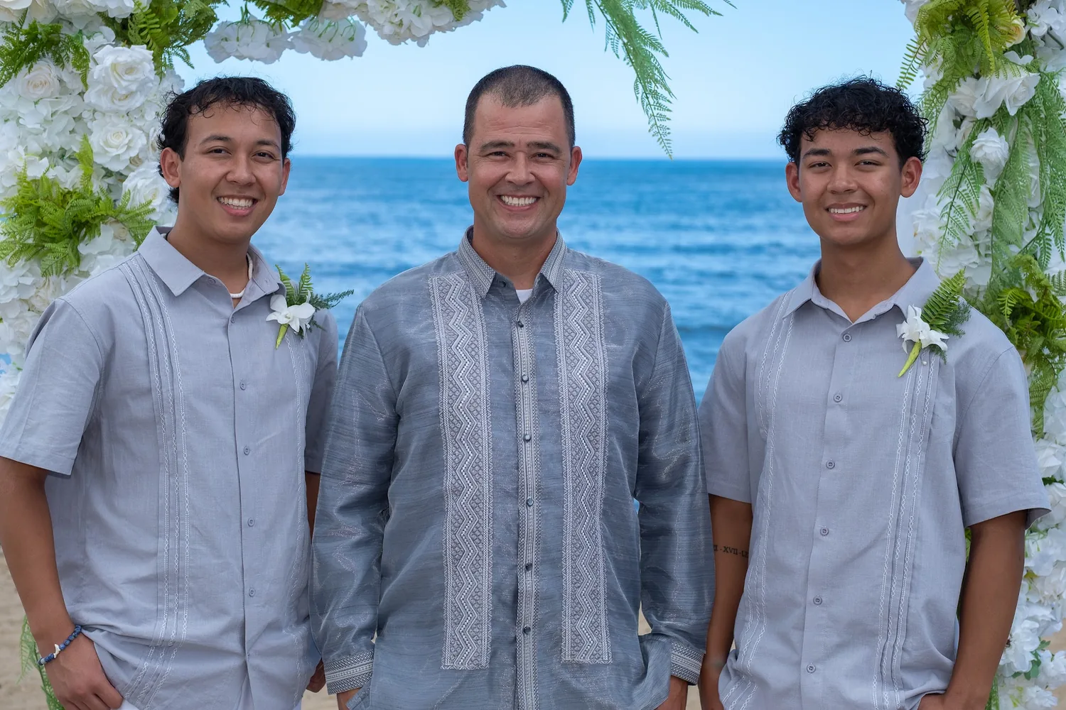 Nate with his sons in matching silver shirts