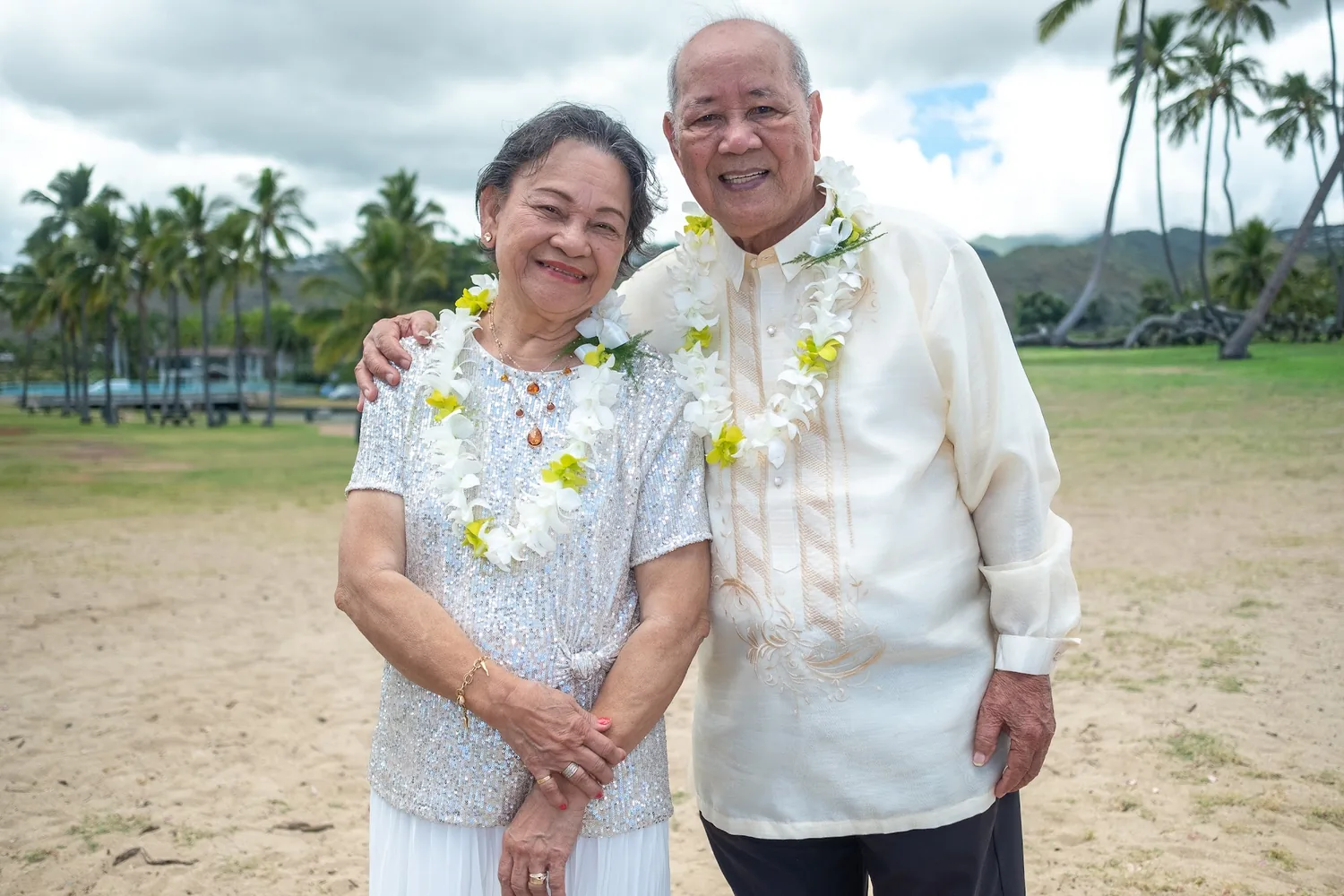 Their parents smiling on the beach