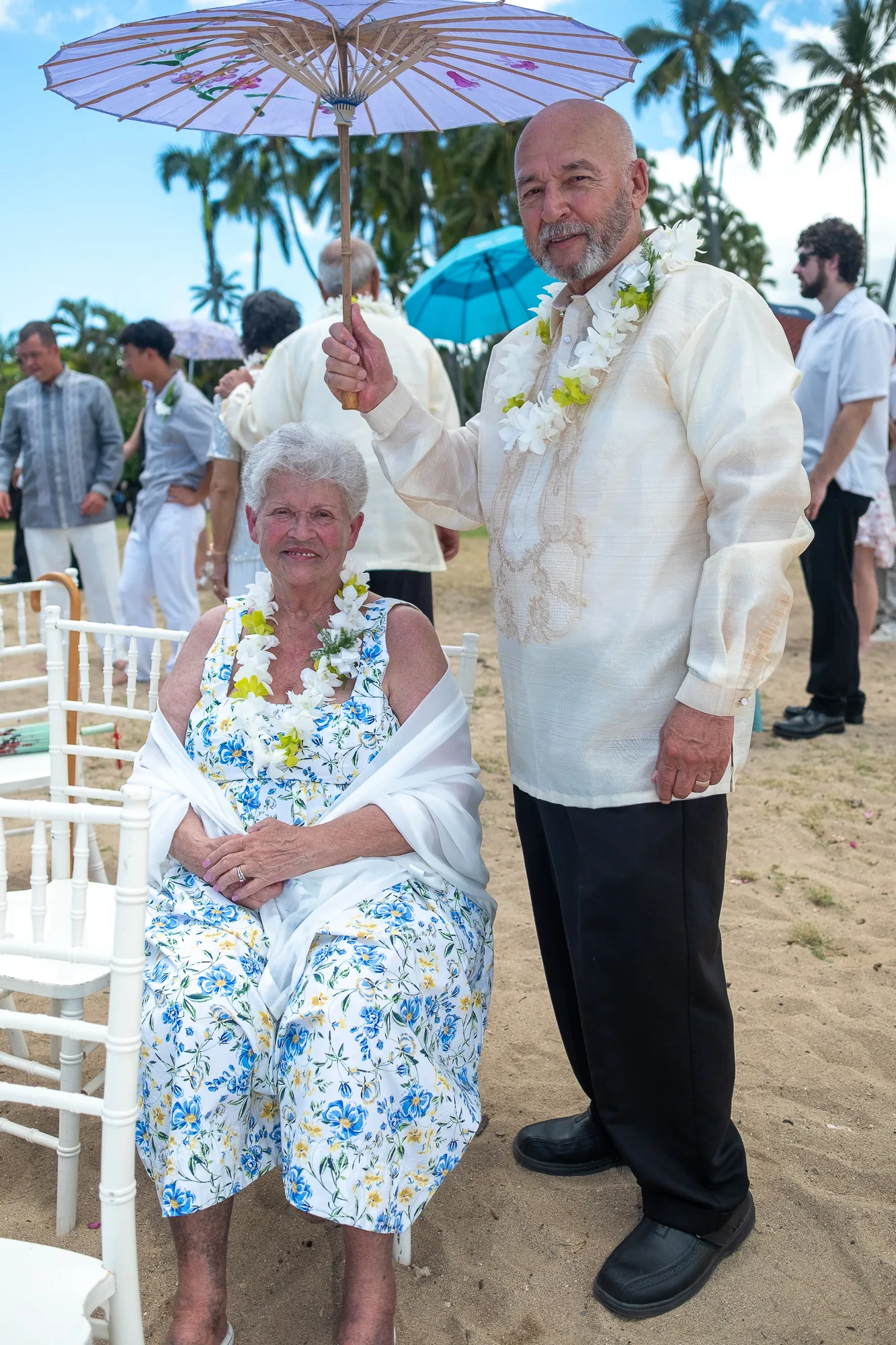 Their parents with a white parasol
