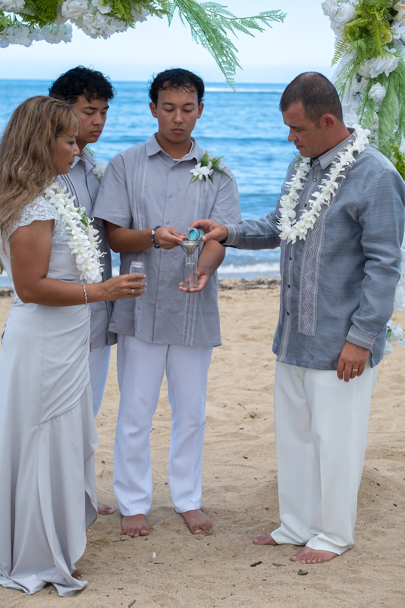 The ring exchange with their sons beside them
