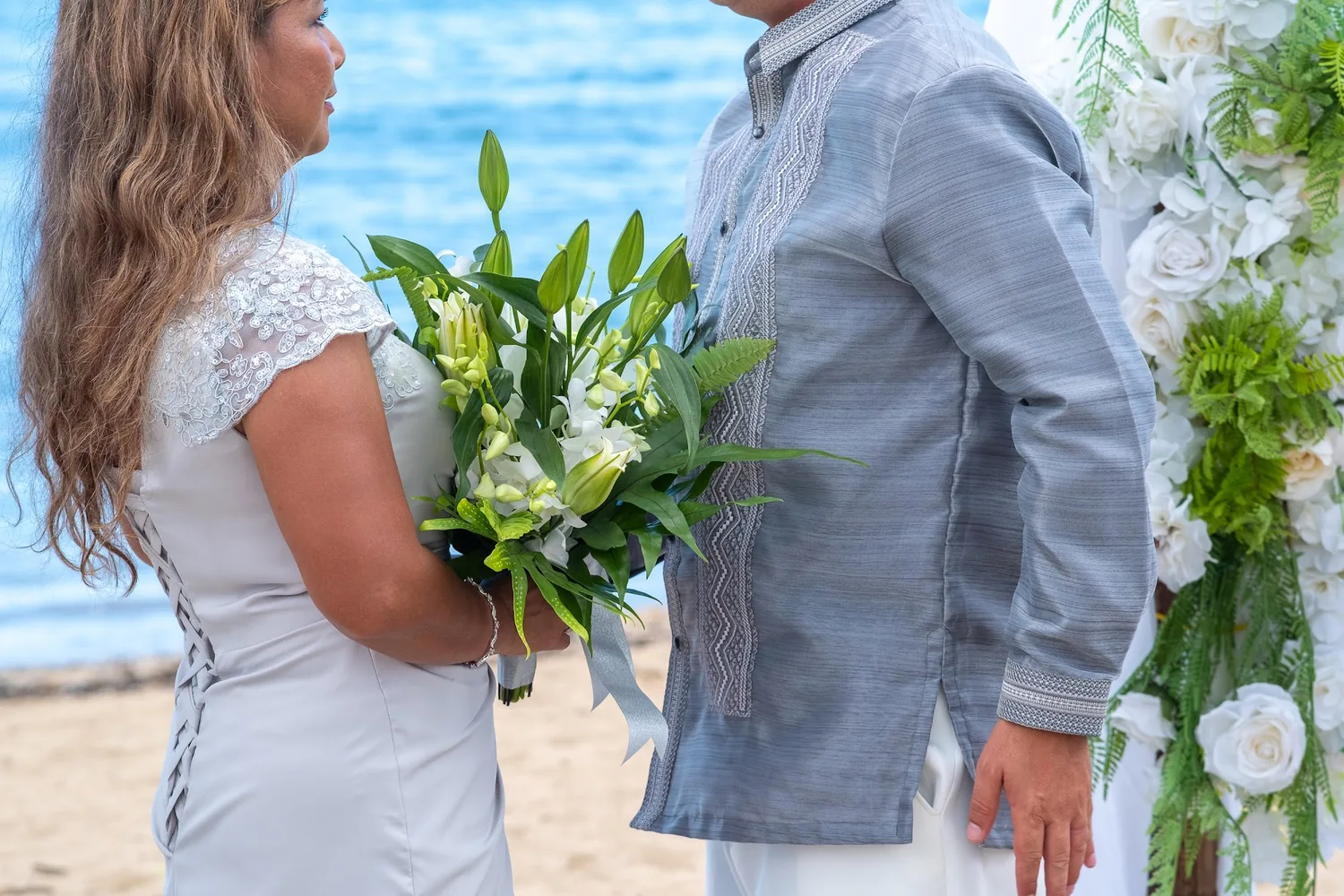Rose with her white bouquet at the arch