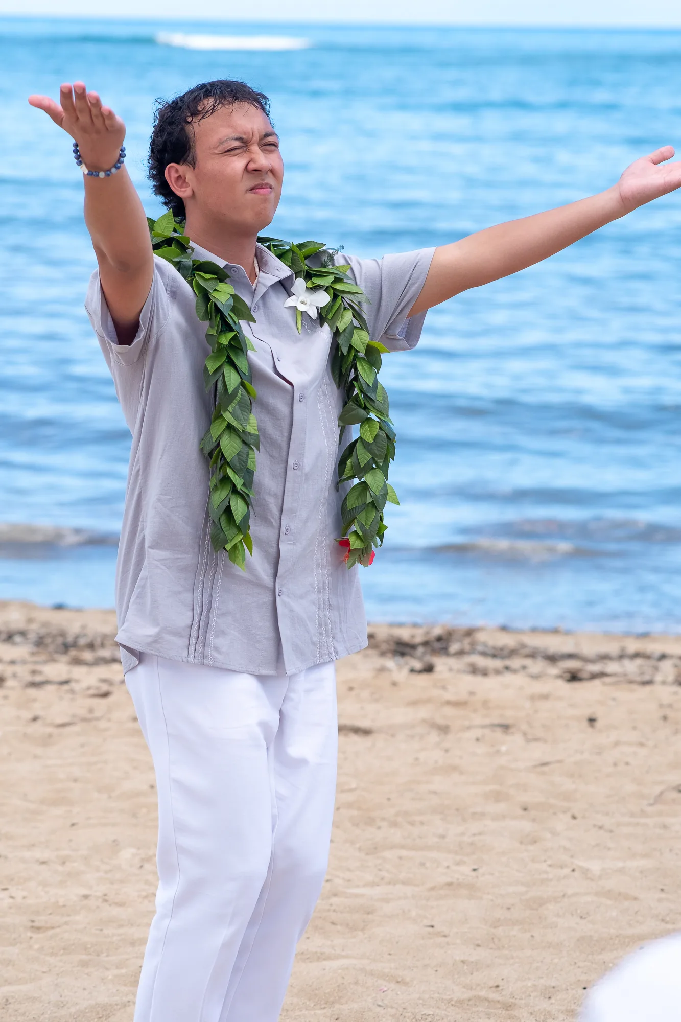 Their son dances the hula for Rose and Nate on the sand