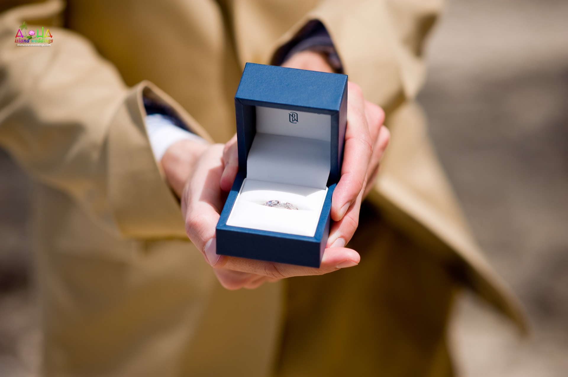 An engagement ring held out for a proposal on Oahu