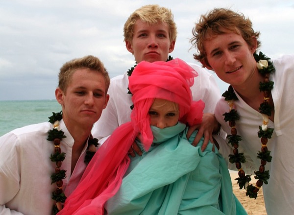 The kids in their leis on the sand, from the aisle