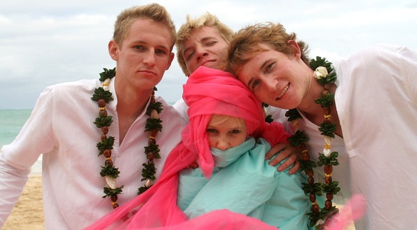 Teri and Dennis with their children on the beach, in the morning light