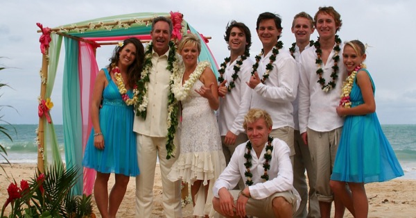 The kids in their leis on the sand, in the morning light