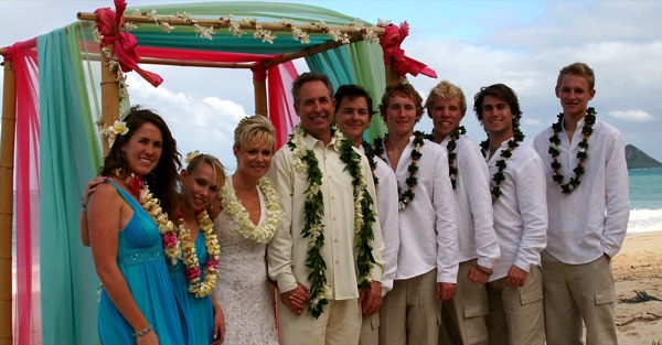 Teri and Dennis with their children on the beach, close together