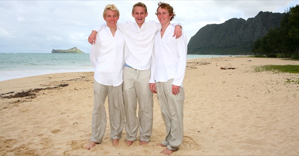 Teri and Dennis with their children on the beach, in the sunshine